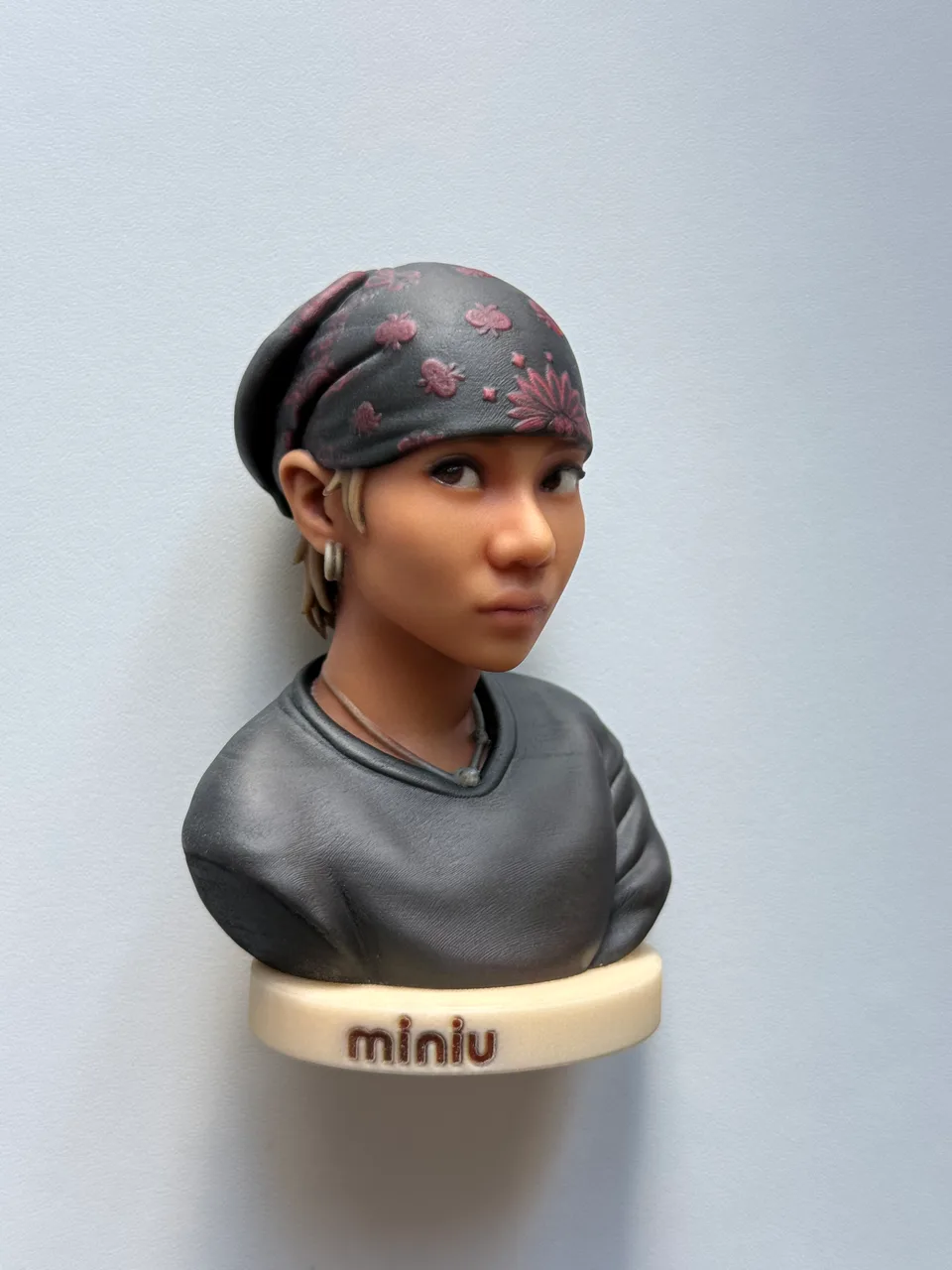Buste 8 cm d'une jeune femme au bandana noir a fleurs roses et sweat gris, socle creme grave miniu